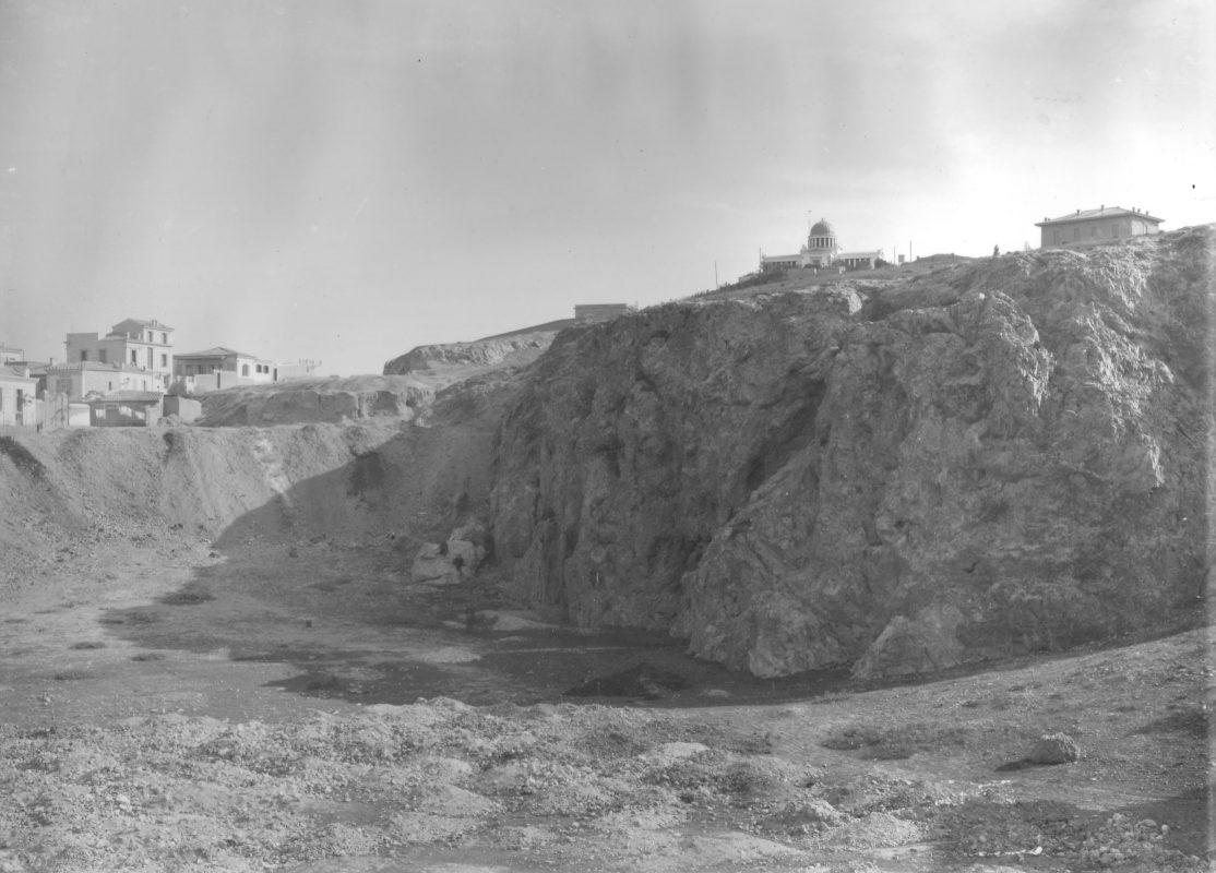 The chasm of the ancient barathron before it was filled up: here it is crowned by the vaulted rooftop of the Observatory; to the left, the neighbourhood of Petralona (Nicholson Museum, Professor W.J. Woodhouse Collection).